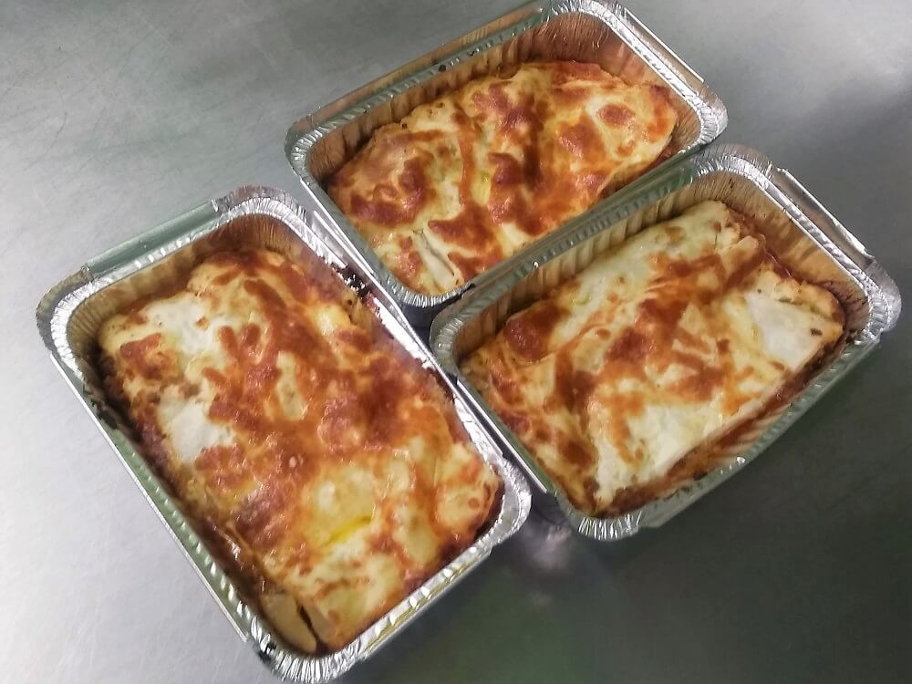 Three individual servings of beef lasagne