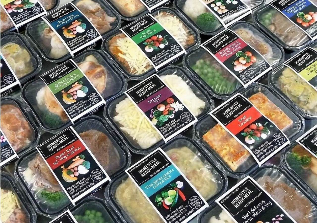 Range of ready meals in their packaging, vacuum sealed back trays with a protective film and cardboard sleeve.