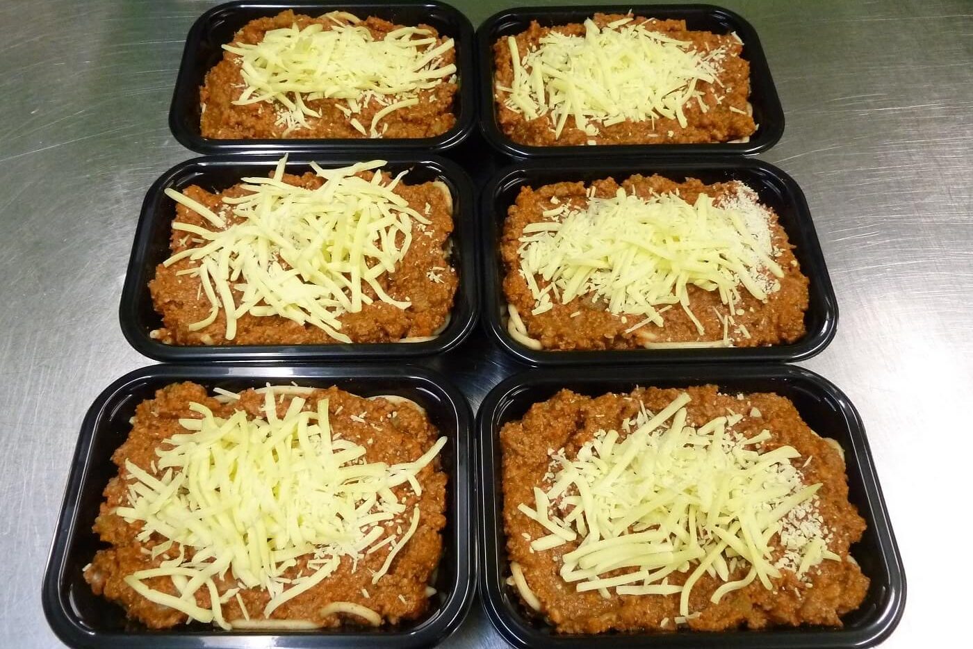 Six Pasta Bolognaise ready-meals in packaging trays